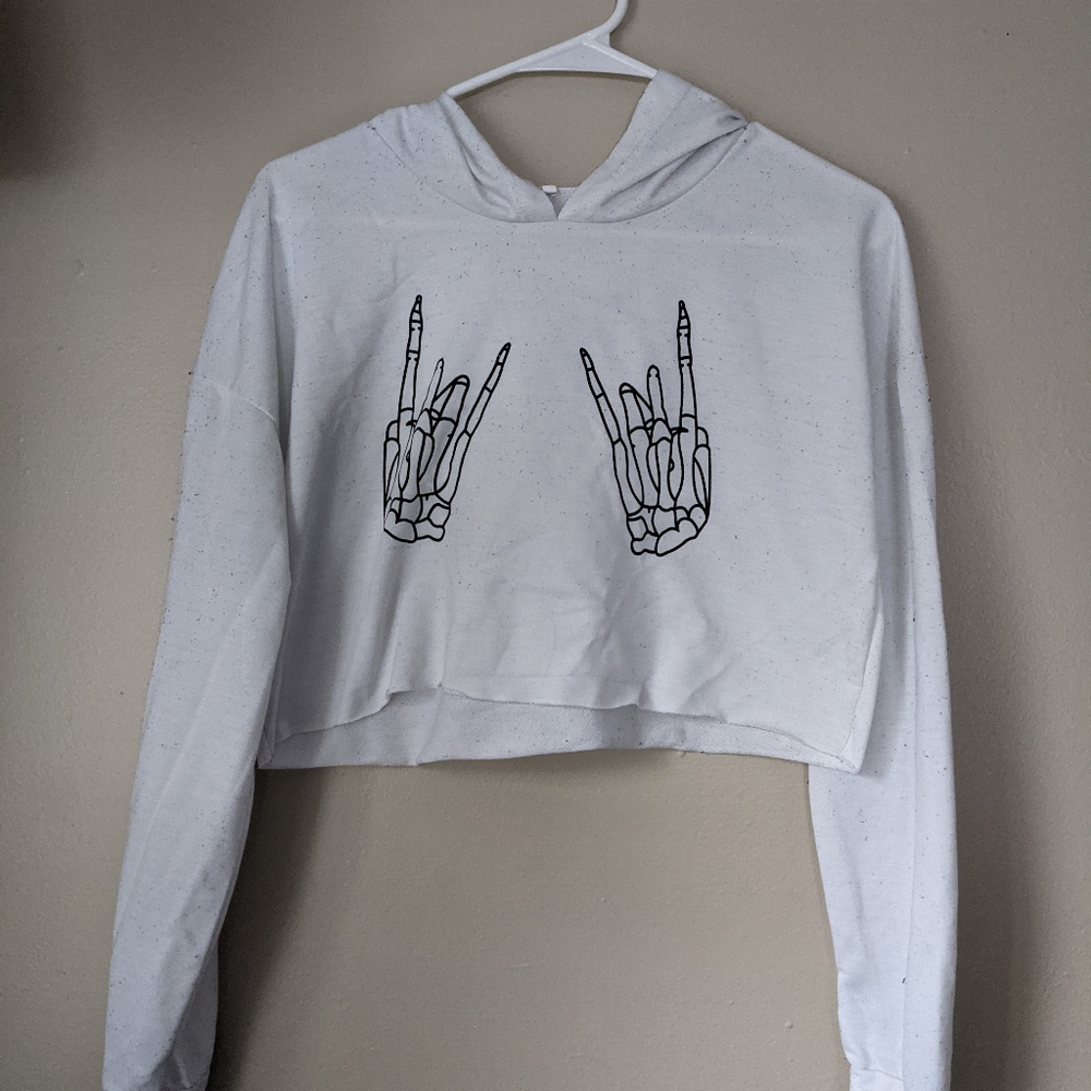 Small crop skeleton hands rock on shirt